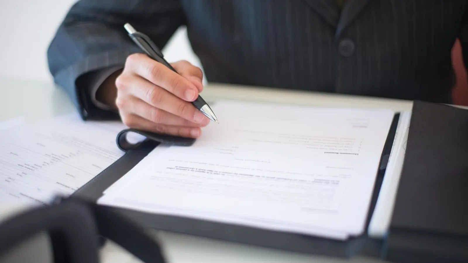 Signing a document at a desk