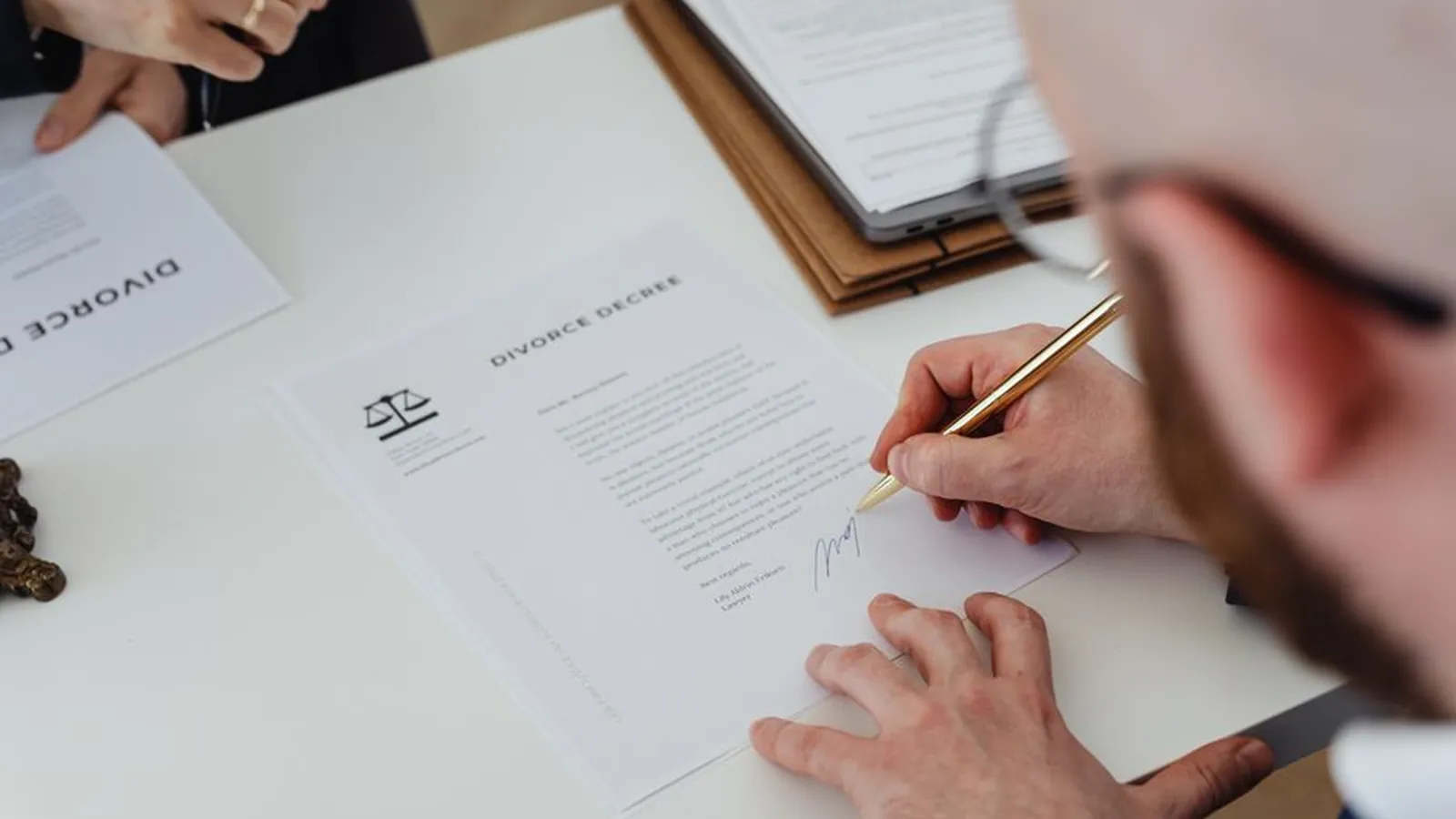 Signing a divorce decree at a desk