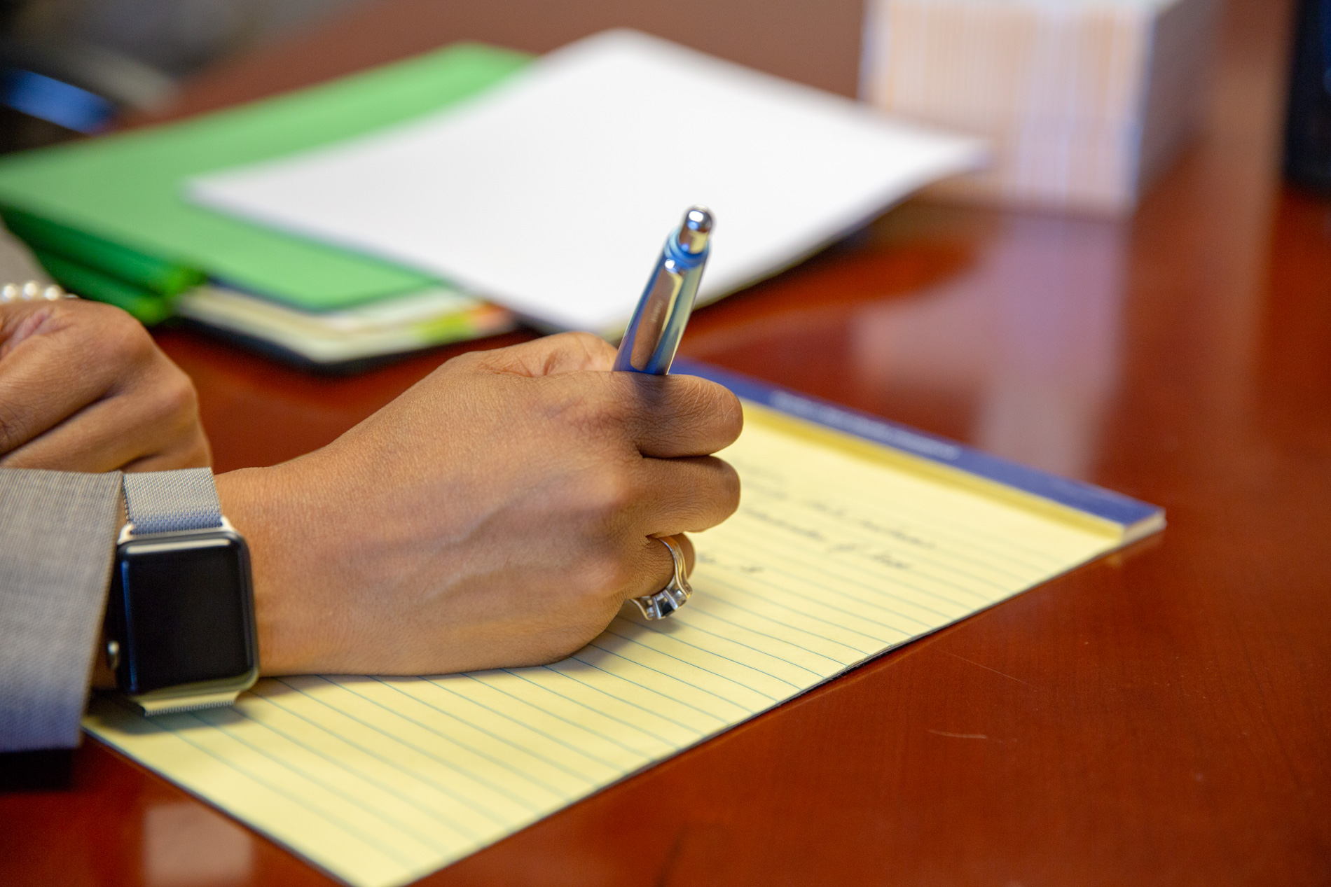 Photo of a Man Writing on Paper