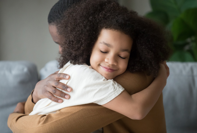 Photo of a Girl Hugging Her Father