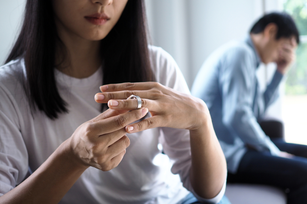 Photo of a Woman Taking off Her Ring