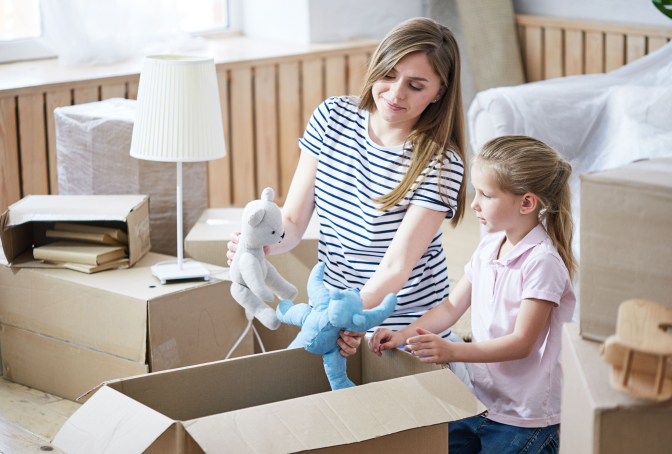 Photo of a Mother and Child Packing Stuffs