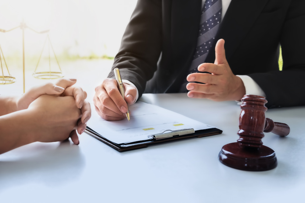 Divorce Attorney Meeting Lawyer discussing legal matters with a client in an office.
