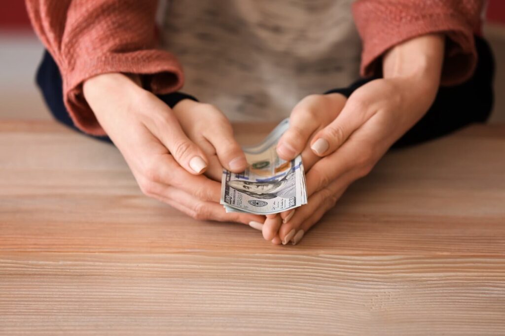 Woman with her son holding dollar